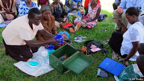 In this April 4, 2012 photo, women affected by AIDS share stories of survival at the Reach Out clinic on the outskirts of Kampala, Uganda. The clinic receives money from the U.S. President's Emergency Plan for AIDS Relief, or PEPFAR. [AP File Photo]