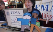 New York, N.Y., Dec. 15, 2012 -- Flat Stanley and Flat Stella visit a FEMA Disaster Recovery Center (DRC) specialist who is discussing mitigation best practices with Hurricane Sandy survivors. 