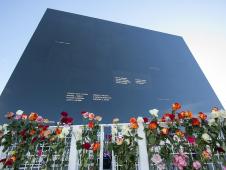 The Space Mirror Memorial with flowers in the foreground.