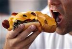 A man takes a bite from a hot dog in Hollywood, California October 3, 2007. REUTERS/Lucy Nicholson