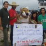 Peace Corps volunteer Michelle Cisz in Paraguay with local volunteers and their mascot, a jaguar used by the volunteers to get people interested in their community projects, like this street clean-up campaign.