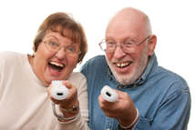 Senior couple holding gaming controllers and having fun.