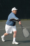 Man playing tennis - Click to enlarge in new window.