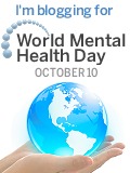 hands holding a globe with World Mental Health Day written above