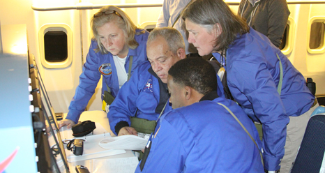 Airborne Astronomy Ambassadors (from left) Constance Gartner, Vince Washington, Ira Hardin and Chelen Johnson at the educators’ work station aboard the SOFIA observatory during a flight on the night of Feb. 12-13, 2013.