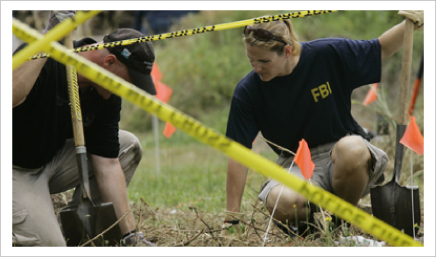 An FBI agent and a local crime scene investigator search for clues in the murder of a newborn baby in Ocean City, Maryland. AP Photo.