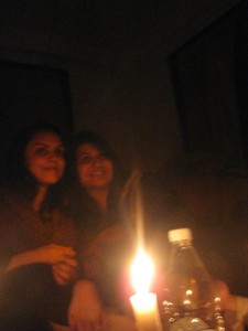 Indian girls pose by candlelight with bottled water
