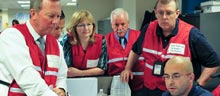 Personnel from FEMA and other federal agencies work side-by-side in FEMA's National Response Coordination Center, preparing for Hurricane Irene