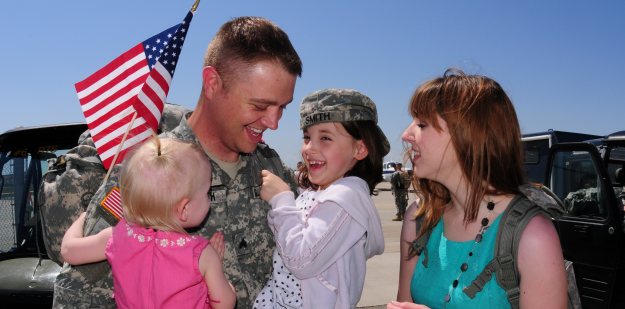 soldier is greeted by his family upon returning from a deployment