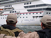 Two CBP Air and Marine agents view the Carnival Triumph as they approach the disabled ship.