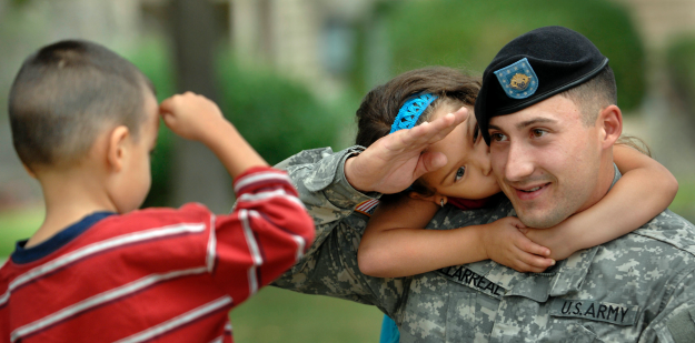 Army Soldier saluting a child