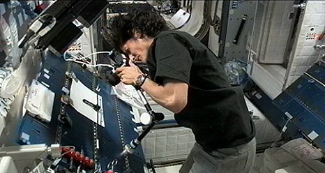 NASA astronaut Suni Williams photographing InSPACE-3 vial assembly after particles redistribution operation on the International Space Station. (NASA)