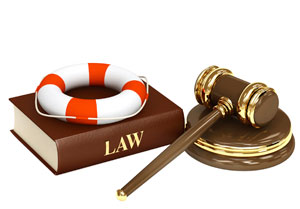 Photograph of a law book, a gavel, and a life preserver.