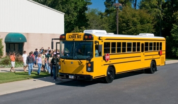 Image of students boarding a yellow school bus