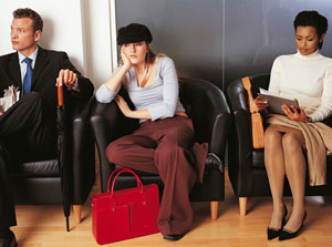 Photograph of a bored looking teen girl sitting between two adults waiting for a job interview.