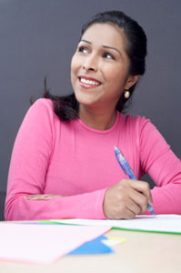 Photograph of a woman filling out forms.