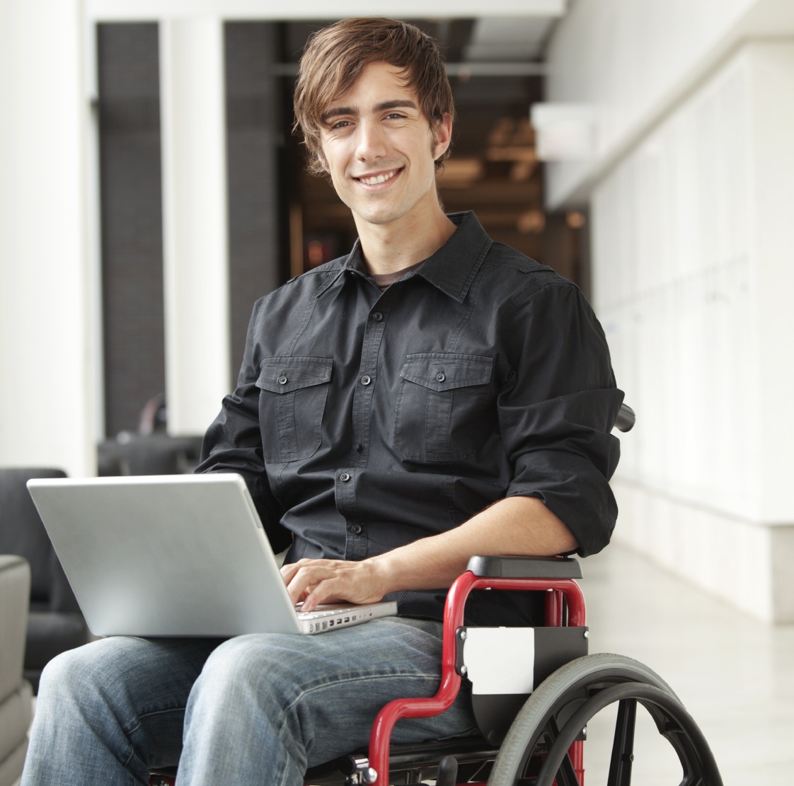 Young man in wheelchair on laptop