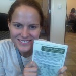 Emily McCormick holding a clinical treatments guidelines brochure.