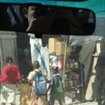 Araceli taking pictures of the streets of Haiti from her car