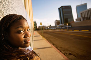 Photograph of a young woman looking over her shoulder.