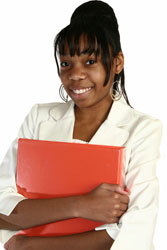 Photograph of a young woman wearing a suit and holding a notebook.