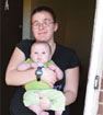 A mother and child outside their Asheville, N.C. in December 2010. The family found a home through a program that helps individuals and families experiencing chronic homeless.