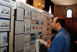 Dr. John Paul SanGiovanni reviews a poster presentation.