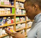 Woman looking at a pill bottle.