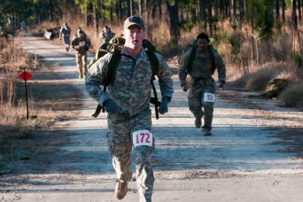 Sgt. Douglas McKee, of the 96th Civil Affairs Battalion, participates in the Fort Bragg Post Combat Cross Country Meet, Saturday, at Smith Lake. McKee was one of 103 servicemembers who vied to represent Fort Bragg at the Bataan Death March in New Mexico, March 17. The top five male and top five female finishers at the meet receive qualification slots. (Photo by Tina Ray/Paraglide)