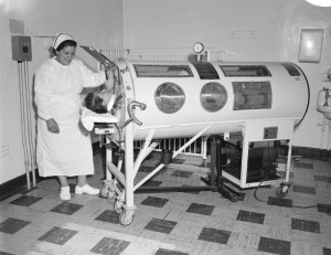 nurse caring for patient in an iron lung