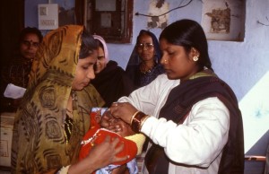 Health care workers in India administer oral polio vaccine