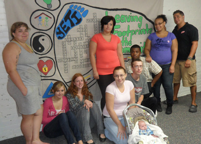 Photograph of young people in front of their completed mural.