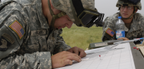 Soldier working on obtaining coordinates on map