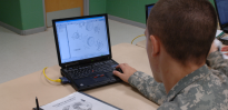 Army mechanic training with computer