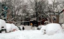 A neighborhood street covered 3 foot deep in snow