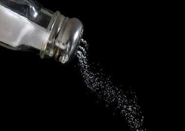 Stock image of salt shaker pouring salt