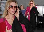 Pretty in pink: Brandi Glanville lands back in Los Angeles as she defends talking about her ex, 'I have to promote my book'