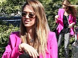 Donning a hot pink menswear-inspired blazer atop a loose black blouse and her trendy jeans, the actress looked far from the usual office worker.