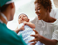 Photo: Mother with doctor and newborn