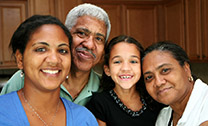 family smiling together in a kitchen