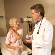 Doctor is giving a diagnosis to an elderly woman patient