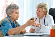A woman doctor giving an elderly woman some advice