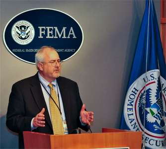 FEMA Administrator Craig Fugate stands at a podium during a press conference.