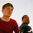Photograph of two teen men standing together.