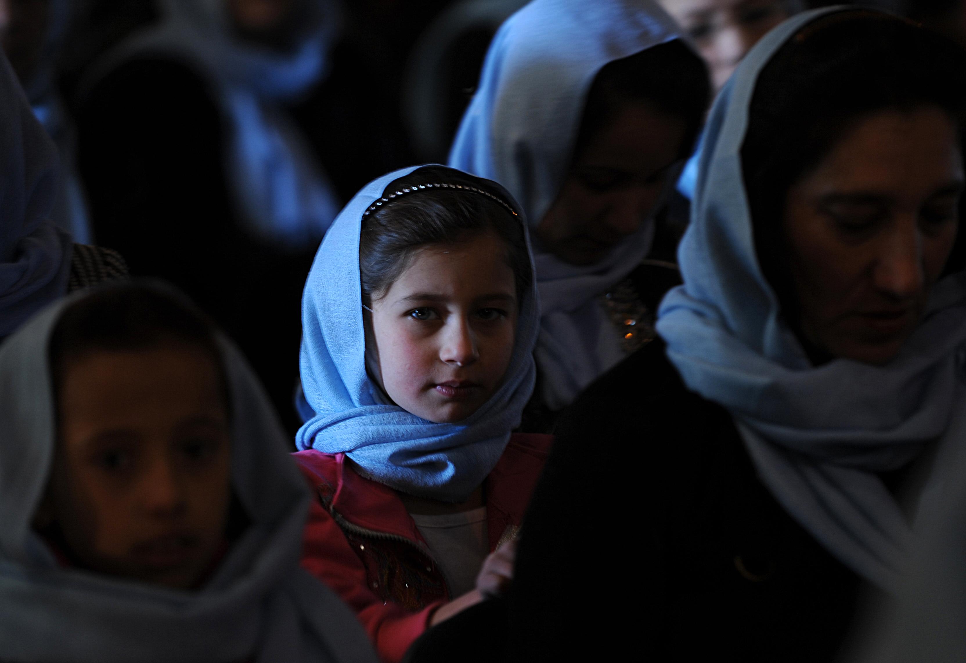 An Afghan girl looks at the camera during a Women's Day ceremony held by the All Afghan Women Union in Kabul on March 8, 2009. 