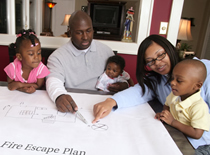 Photo of young family looking at preparedness plans.