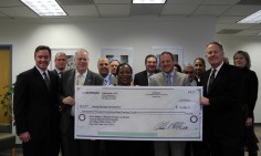 Regional Administrator Denise Pease accepts large rebate check