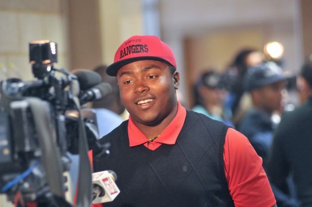 Madison High School football player Jalen Privott speaks to a TV reporter after signing a football scholarship to attend Northwestern Oklahoma State University Wednesday during National Signing Day. Photo: Robin Jerstad