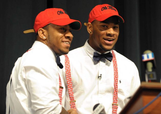 Grayson High School football player Robert Nkemdiche, right, the nation's top recruit, is congratulated by his brother Denzel during Robert Nkemdiche's announcement to play college football for Ole Miss, at a Grayson, Ga., signing ceremony Wednesday Feb. 6, 2013. Denzel Nkemdiche also plays for the Rebels. (AP Photo/David Tulis) Photo: Dave Tulis, Associated Press / FR170493 AP