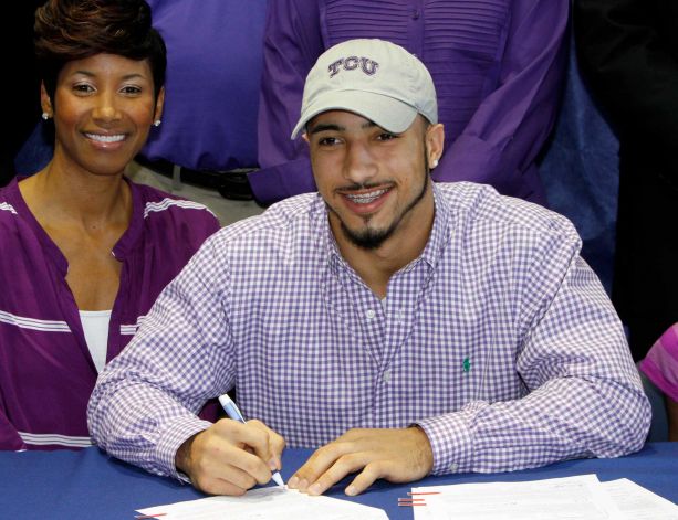 Nikki Luper watches her son, Cameron Echols-Luper, signs a letter of intent to attend TCU and play college football during National Signing Day on Wednesday, Feb. 6, 2013, in Auburn, Ala. (AP Photo/Butch Dill) Photo: Butch Dill, Associated Press / FR111446 AP